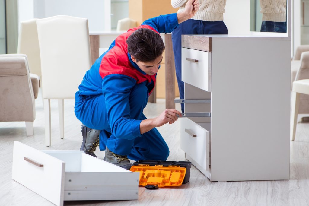 Professional furniture assembler installing drawers during a furniture assembly service in Delaware County