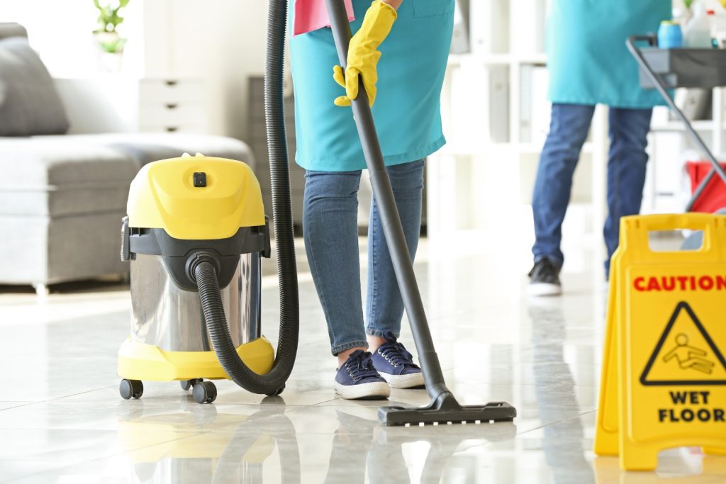 Professional cleaner vacuuming a floor during commercial cleaning services in Philadelphia