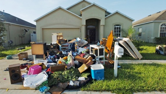 Residential junk removal services for cluttered front yard in Delaware County