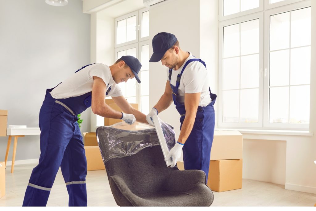 Professional movers wrapping a chair for safe transport during a move in Delaware County