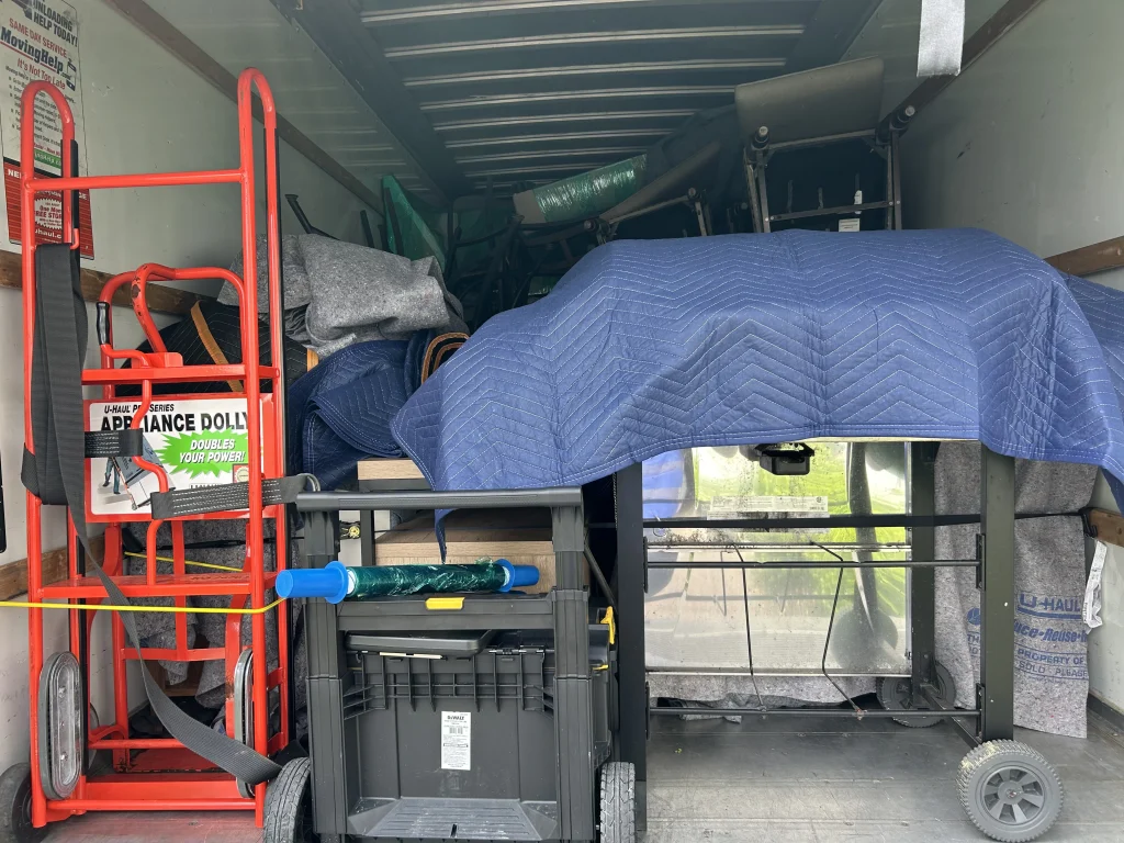 Montgomery County moving truck loaded with wrapped furniture and equipment
