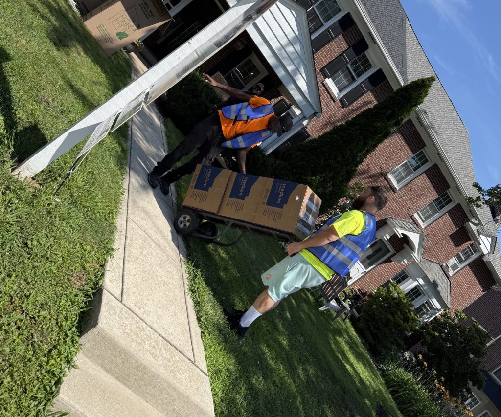 Professional Delaware County movers transporting boxes from a residential home