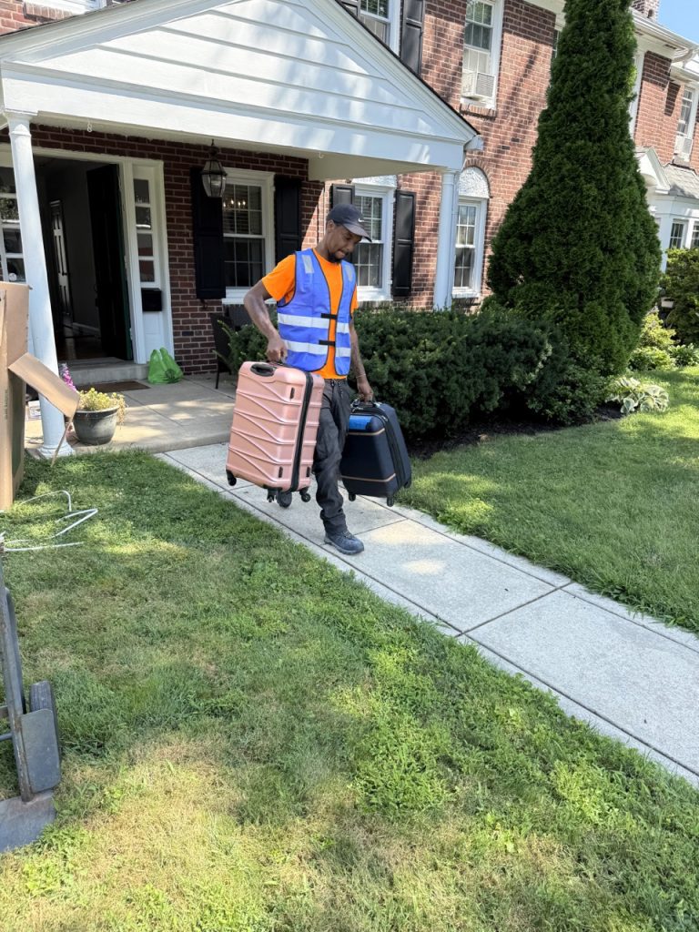 Professional Chester County movers carrying furniture into a home