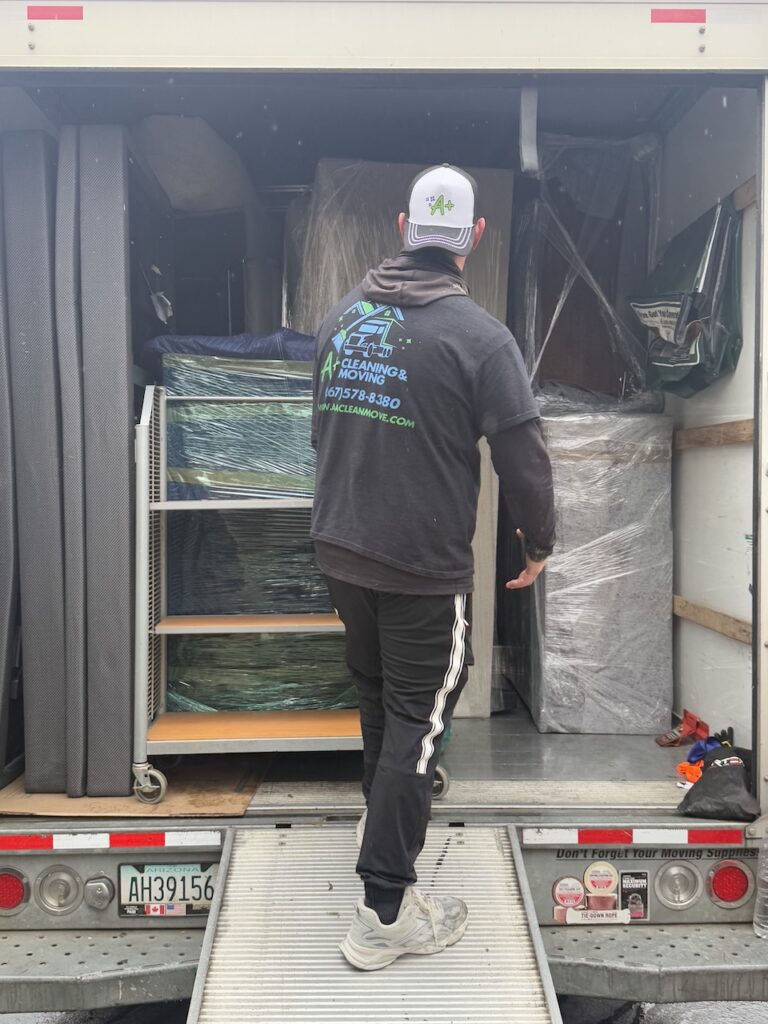 Apartment movers carrying furniture down stairs during a move