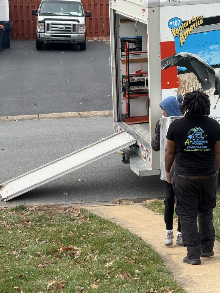 Labor only movers loading furniture and boxes into a moving truck