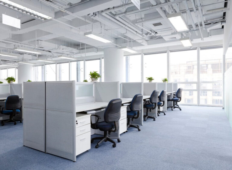 Office movers relocating desks and furniture during a commercial move