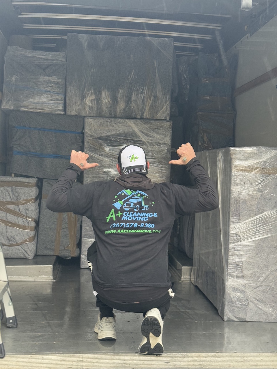Professional movers carrying furniture for a residential move across Pennsylvania, New Jersey, and Delaware.