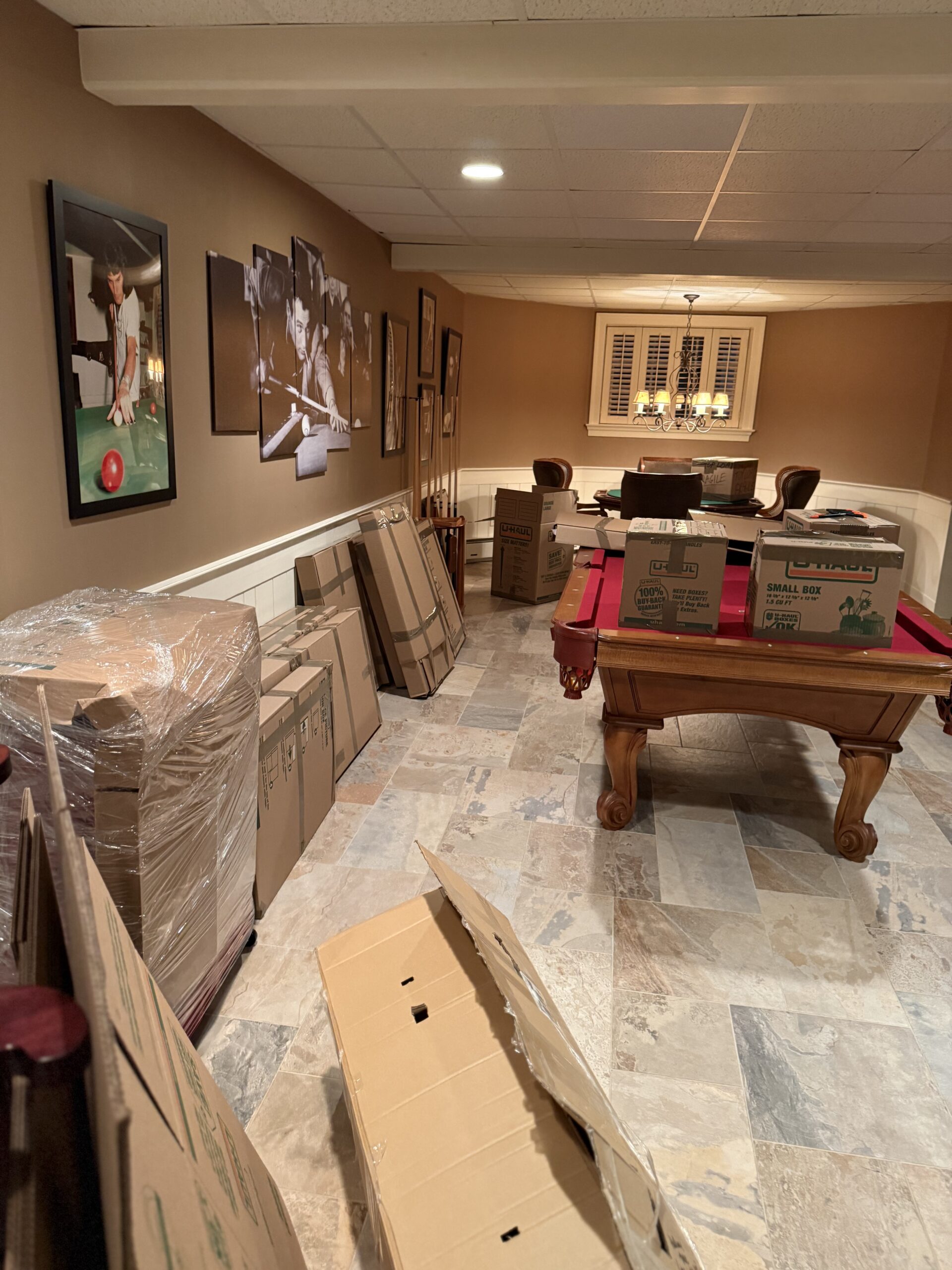 Professional movers handling protected household goods during a residential move
